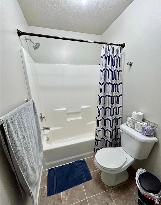 5288 W Solafax Ln Unit 34-1, Herriman, UT 84096 - bathroom featuring shower / tub combo with curtain, toilet, tile patterned floors, and a textured ceiling
