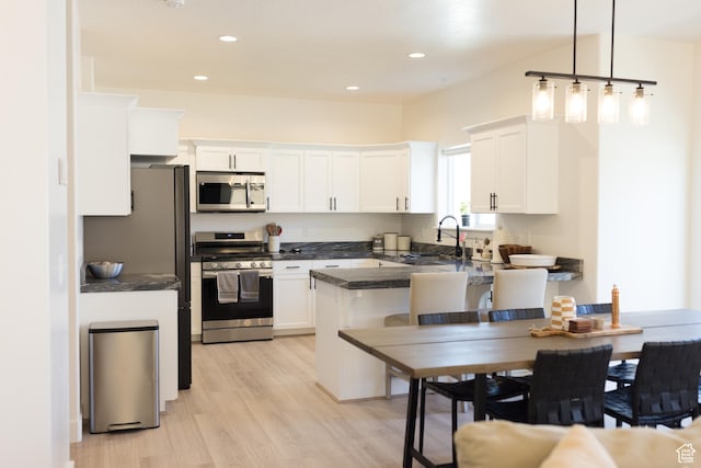 4745 E Silver Moon Dr, Eagle Mountain, UT 84005 - kitchen with appliances with stainless steel finishes, dark countertops, a sink, white cabinetry, and recessed lighting