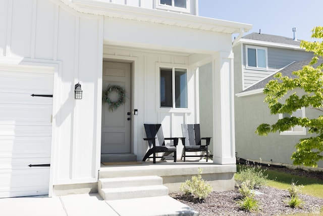 4745 E Silver Moon Dr, Eagle Mountain, UT 84005 - property entrance featuring board and batten siding, a porch, and a garage