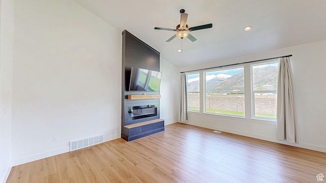 492 N 910 E, Salem, UT 84653 - unfurnished living room featuring a large fireplace, wood finished floors, ceiling fan, vaulted ceiling, and baseboards