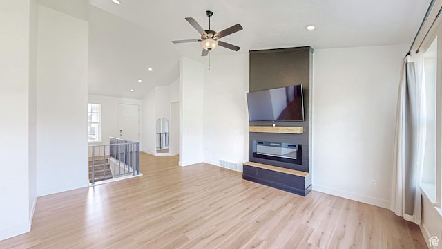 492 N 910 E, Salem, UT 84653 - unfurnished living room featuring lofted ceiling, wood finished floors, a ceiling fan, baseboards, and a large fireplace