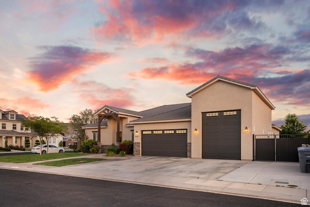 3691 W 2800 S, Hurricane, UT 84737 - view of front of home with a garage, stucco siding, driveway, stone siding, and a tile roof