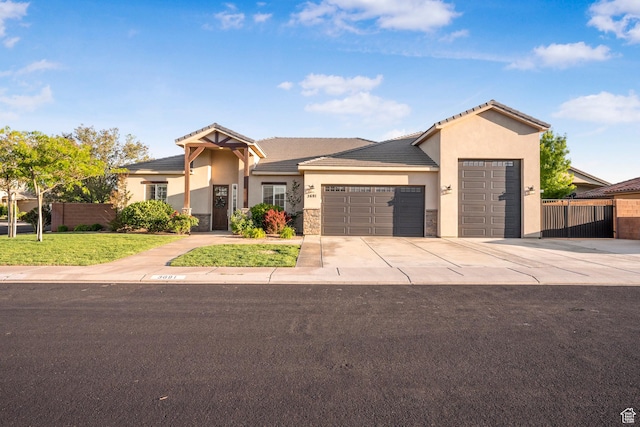 3691 W 2800 S, Hurricane, UT 84737 - view of front of home with a garage, concrete driveway, stucco siding, and a tile roof