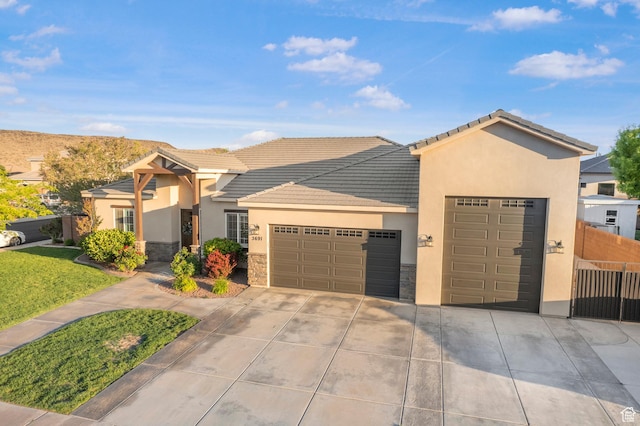 3691 W 2800 S, Hurricane, UT 84737 - ranch-style home with stone siding, an attached garage, stucco siding, driveway, and a tile roof