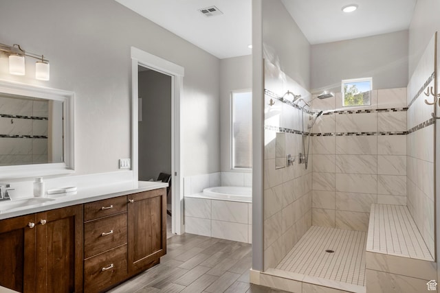 3691 W 2800 S, Hurricane, UT 84737 - full bath featuring a garden tub, vanity, tiled shower, and wood finished floors