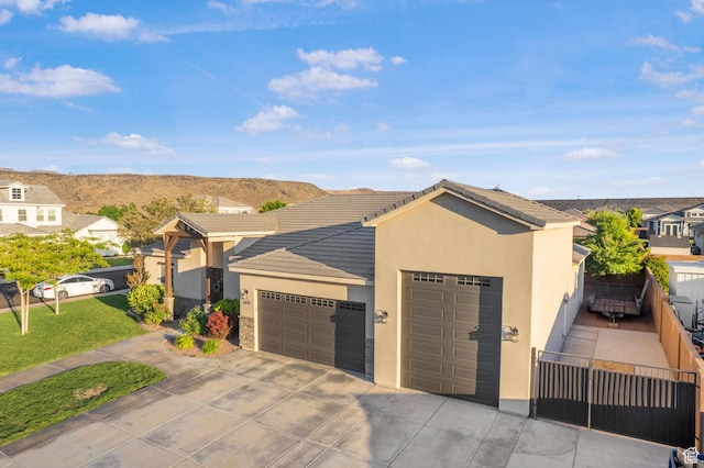 3691 W 2800 S, Hurricane, UT 84737 - view of front of home with a tile roof, a garage, concrete driveway, and stucco siding