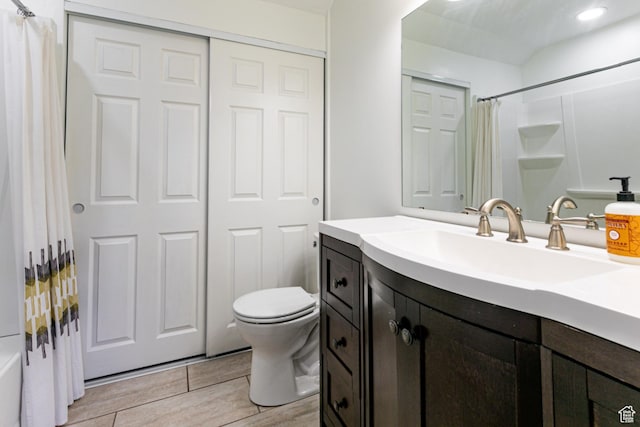 545 W Applewood Dr S # 10, Bountiful, UT 84010 - bathroom with vanity, wood finished floors, toilet, and shower / bathtub combination with curtain