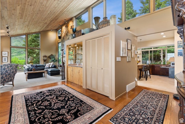 4517 S Abinadi Rd, Millcreek, UT 84124 - entrance foyer with healthy amount of natural light, wooden ceiling, hardwood / wood-style flooring, a high ceiling, and baseboards