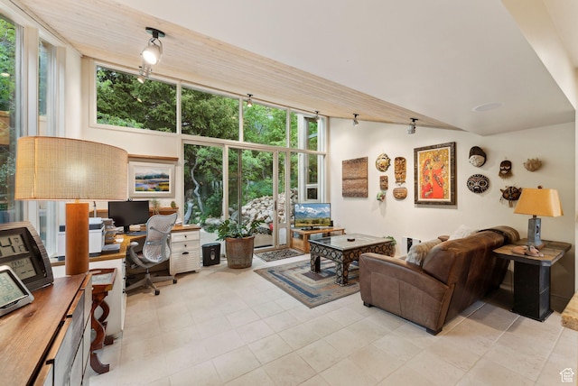 4517 S Abinadi Rd, Millcreek, UT 84124 - living room featuring a desk, light tile patterned floors, and lofted ceiling