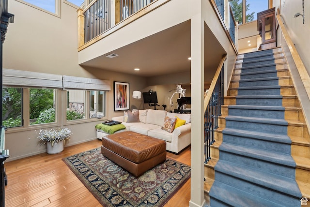 4517 S Abinadi Rd, Millcreek, UT 84124 - living room featuring a towering ceiling, stairway, wood finished floors, baseboards, and recessed lighting