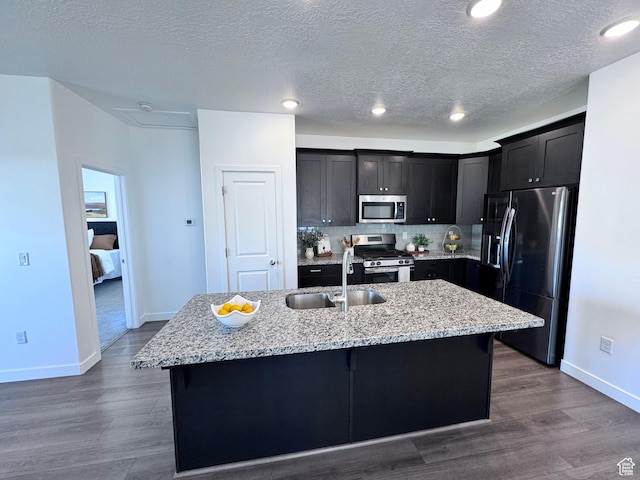 12754 S Quail Lake Dr Unit 126, Riverton, UT 84096 - kitchen with stainless steel appliances, a sink, baseboards, a textured ceiling, and decorative backsplash
