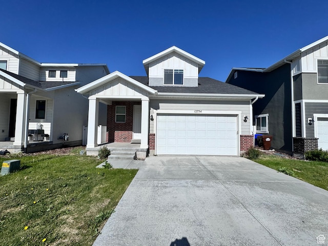 12754 S Quail Lake Dr Unit 126, Riverton, UT 84096 - view of front of house with brick siding, board and batten siding, driveway, an attached garage, and a porch
