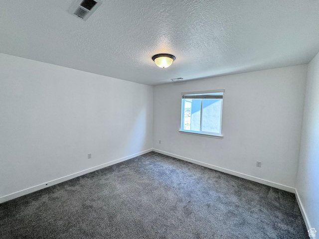 12754 S Quail Lake Dr Unit 126, Riverton, UT 84096 - empty room with dark colored carpet, baseboards, and a textured ceiling