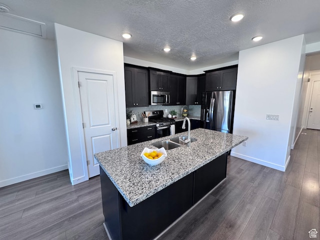12754 S Quail Lake Dr Unit 126, Riverton, UT 84096 - kitchen featuring appliances with stainless steel finishes, a sink, baseboards, dark wood-style flooring, and a textured ceiling