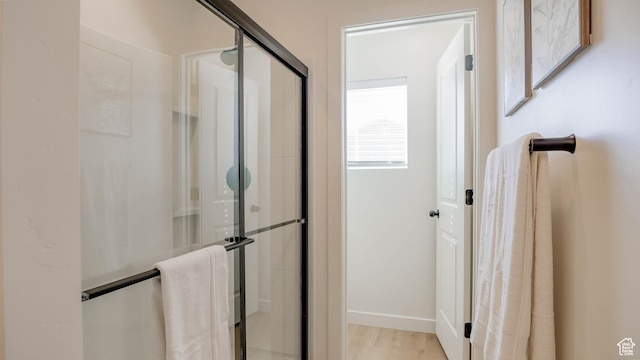 4357 E Longleaf Ln, Eagle Mountain, UT 84005 - full bathroom with a stall shower, wood finished floors, and baseboards