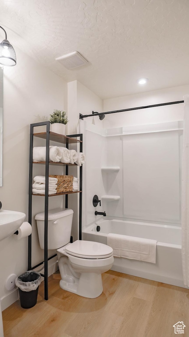 4357 E Longleaf Ln, Eagle Mountain, UT 84005 - bathroom featuring wood finished floors, tub / shower combination, toilet, recessed lighting, and a textured ceiling