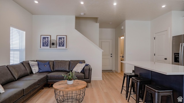 4357 E Longleaf Ln, Eagle Mountain, UT 84005 - living room featuring light wood finished floors, recessed lighting, stairway, and baseboards