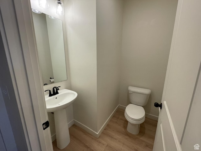 4357 E Longleaf Ln, Eagle Mountain, UT 84005 - bathroom with wood finished floors, toilet, baseboards, and a sink
