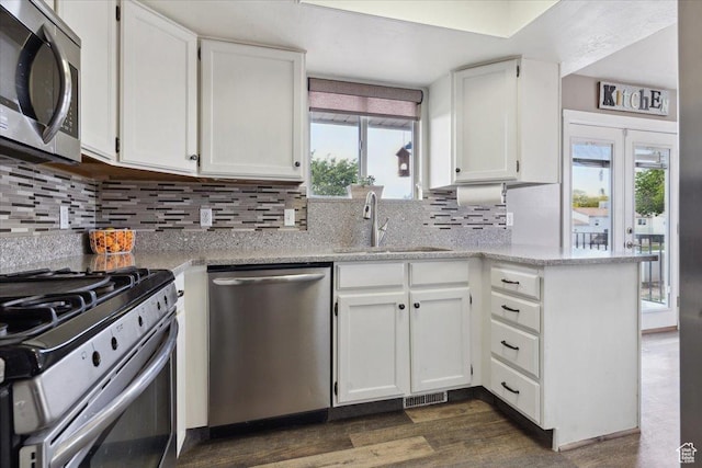 6864 S 3370 W, West Jordan, UT 84084 - kitchen with stainless steel appliances, a sink, white cabinetry, and dark wood-type flooring