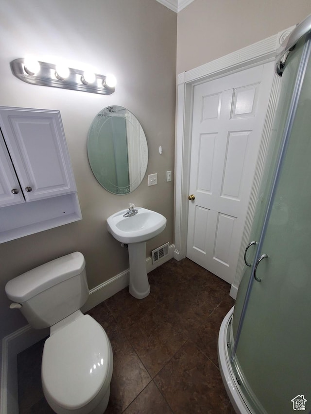 827 E Third Ave N, Salt Lake City, UT 84103 - bathroom featuring baseboards, toilet, and a shower stall