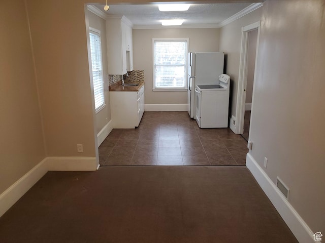 827 E Third Ave N, Salt Lake City, UT 84103 - laundry room featuring ornamental molding, baseboards, and dark tile patterned floors