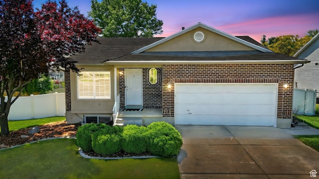 146 S 1125 W, Layton, UT 84041 - view of front facade with concrete driveway, brick siding, a shingled roof, and an attached garage