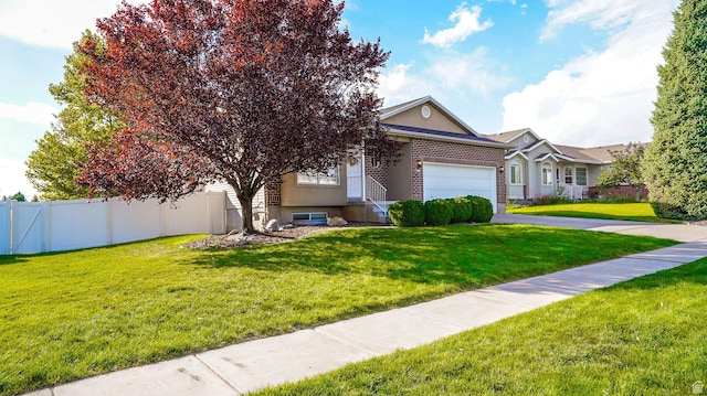 146 S 1125 W, Layton, UT 84041 - view of front of home featuring an attached garage, asphalt driveway, and brick siding