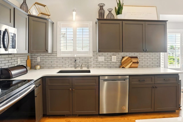 146 S 1125 W, Layton, UT 84041 - kitchen with appliances with stainless steel finishes, a sink, tasteful backsplash, and light countertops
