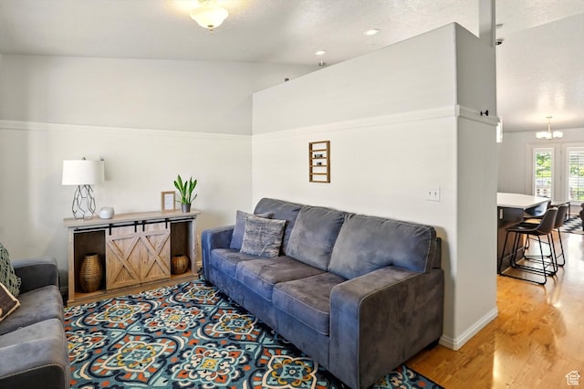 146 S 1125 W, Layton, UT 84041 - living area featuring light wood finished floors, a chandelier, and baseboards