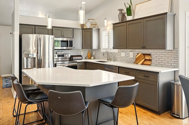 146 S 1125 W, Layton, UT 84041 - kitchen with appliances with stainless steel finishes, a sink, a kitchen breakfast bar, and decorative backsplash
