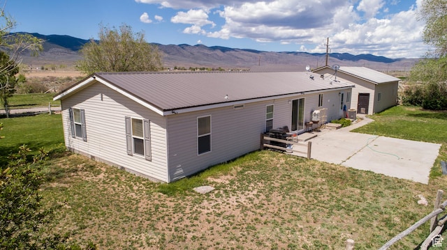 1085 S S River Ridge Ln, Joseph, UT 84739 - rear view of house featuring a patio, a mountain view, a yard, and metal roof