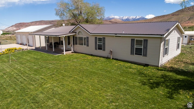 1085 S S River Ridge Ln, Joseph, UT 84739 - rear view of property featuring a mountain view, a yard, a garage, and metal roof