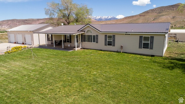 1085 S S River Ridge Ln, Joseph, UT 84739 - back of house with a mountain view, a lawn, metal roof, and a garage