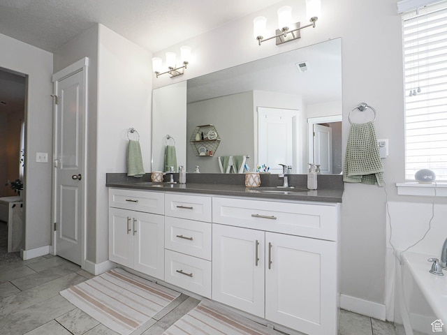 957 W Mckenna Rd, Bluffdale, UT 84065 - full bathroom featuring double vanity, baseboards, and a bathtub