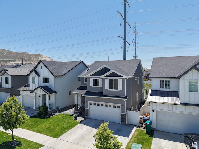 957 W Mckenna Rd, Bluffdale, UT 84065 - modern farmhouse style home featuring a garage, driveway, board and batten siding, a front lawn, and a residential view