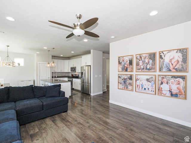 957 W Mckenna Rd, Bluffdale, UT 84065 - living room featuring a chandelier, dark wood-type flooring, a ceiling fan, recessed lighting, and baseboards