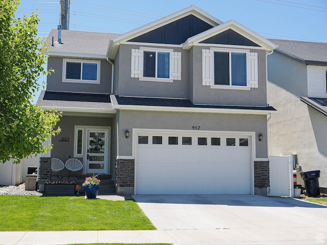 957 W Mckenna Rd, Bluffdale, UT 84065 - craftsman house featuring an attached garage, concrete driveway, stucco siding, and a front lawn
