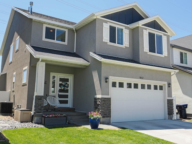 957 W Mckenna Rd, Bluffdale, UT 84065 - view of front of home with central air condition unit, a garage, stone siding, concrete driveway, and stucco siding