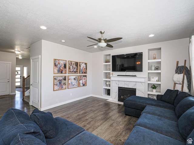957 W Mckenna Rd, Bluffdale, UT 84065 - living room with baseboards, a ceiling fan, dark wood-type flooring, a textured ceiling, and built in features