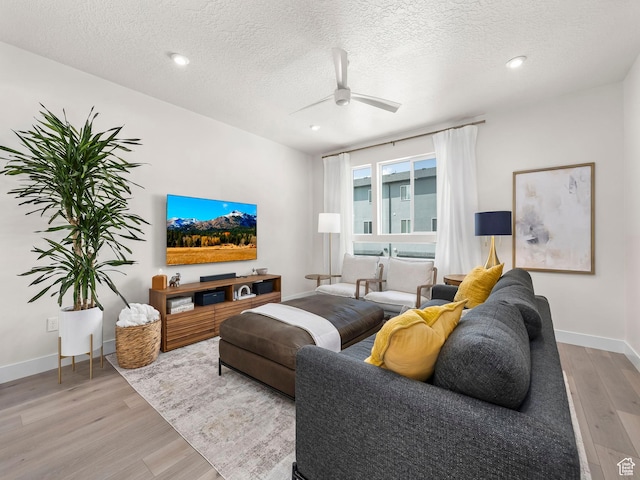1031 W 360 S, American Fork, UT 84003 - living room with light wood-style flooring, a textured ceiling, a ceiling fan, baseboards, and recessed lighting