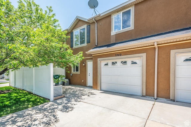 5242 W Cool Water Way S, West Jordan, UT 84081 - view of front of property with stucco siding, a garage, and driveway