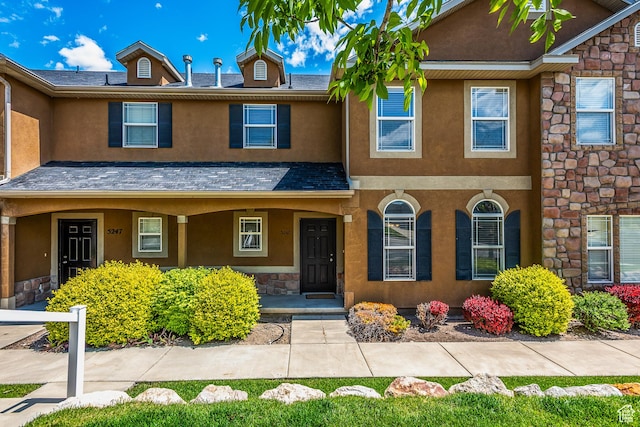 5242 W Cool Water Way S, West Jordan, UT 84081 - townhome / multi-family property featuring stone siding, stucco siding, and a porch