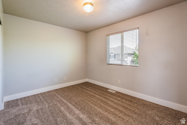 5242 W Cool Water Way S, West Jordan, UT 84081 - unfurnished room with dark carpet, baseboards, and a textured ceiling