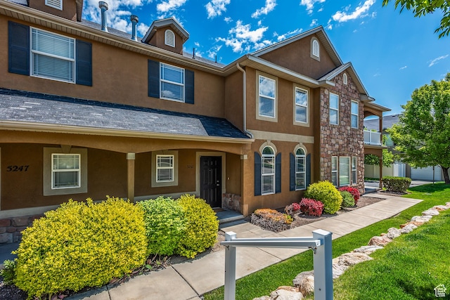 5242 W Cool Water Way S, West Jordan, UT 84081 - townhome / multi-family property with stucco siding, stone siding, and a porch