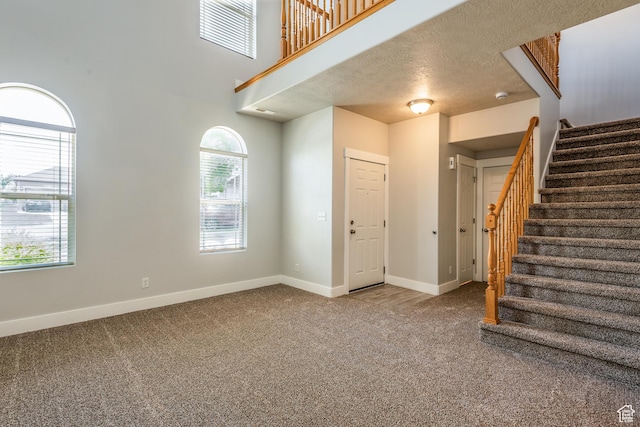 5242 W Cool Water Way S, West Jordan, UT 84081 - foyer entrance featuring carpet, stairs, baseboards, and healthy amount of natural light