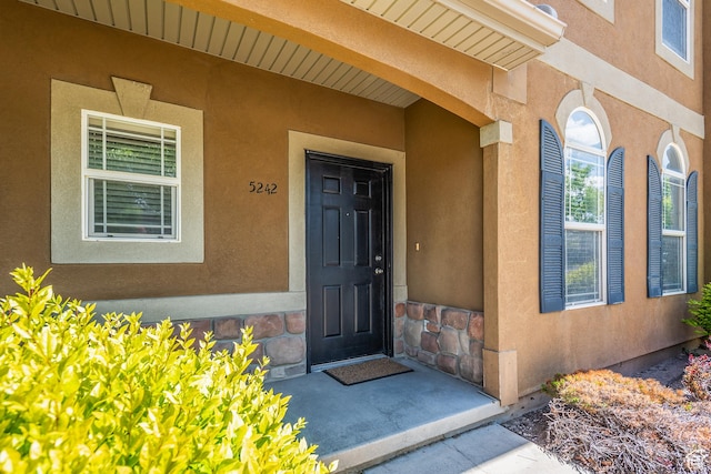 5242 W Cool Water Way S, West Jordan, UT 84081 - view of exterior entry with stucco siding and a porch