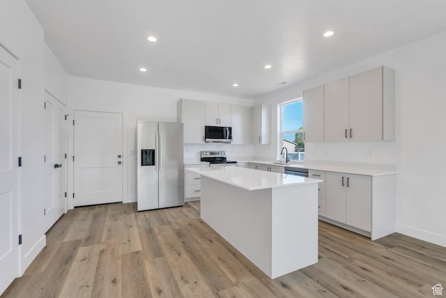 515 N 600 E, Spanish Fork, UT 84660 - kitchen with appliances with stainless steel finishes, a center island, light countertops, light wood-style flooring, and recessed lighting