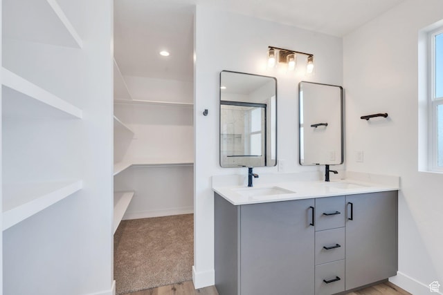 515 N 600 E, Spanish Fork, UT 84660 - bathroom featuring double vanity, wood finished floors, baseboards, a shower, and a walk in closet