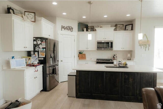 217 S 1230 W Unit 15, Spanish Fork, UT 84660 - kitchen featuring stainless steel appliances, a sink, light countertops, white cabinetry, and light wood-style floors