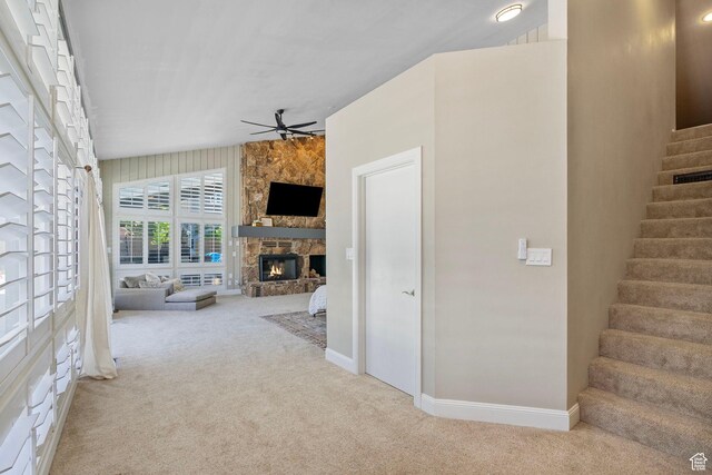 177 S Canyon Ave, Springville, UT 84663 - unfurnished living room with carpet floors, a ceiling fan, stairs, a stone fireplace, and baseboards